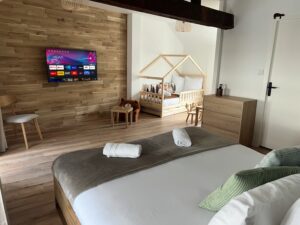 Chambre au deuxième étage d’une maison cabane à Cholet avec lits, TV et jeux