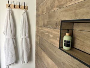 Salle de bain au premier étage d’une maison cabane à Cholet avec peignoirs